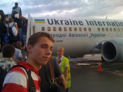 Boy getting on Ukraine International Plane